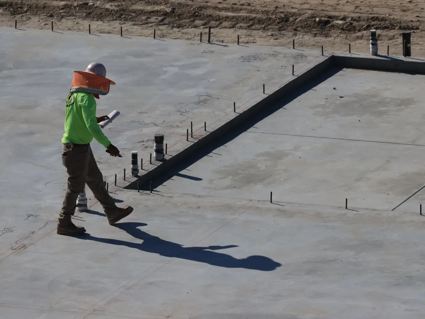 Concrete professional inspecting a slab and its transitions